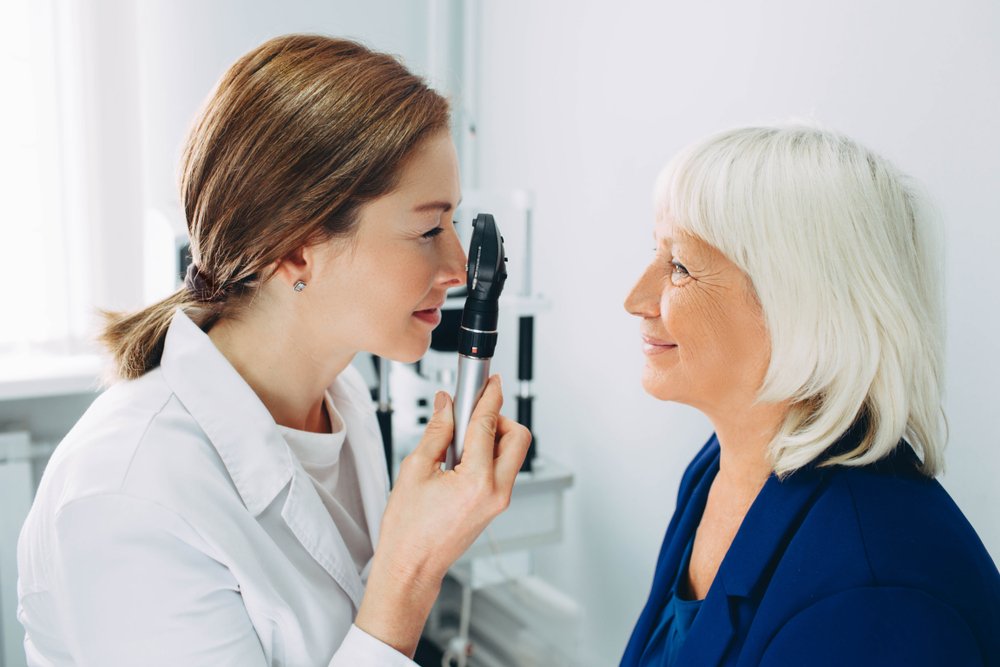 Elderly woman talking with optometrist during Eye Exam