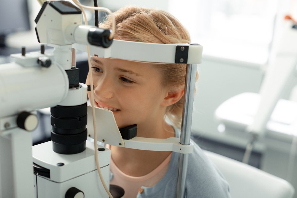 Photo of a female kid during an eye exam
